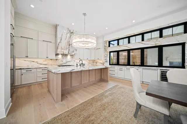 Professional real estate photography of a luxury kitchen with calacatta marble island in new construction home, Bethesda MD