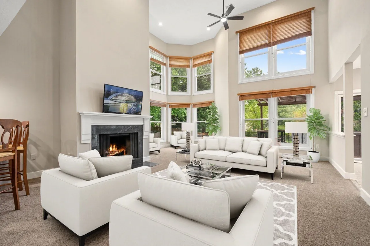 Example of a virtually staged living room with a fireplace and bay windows