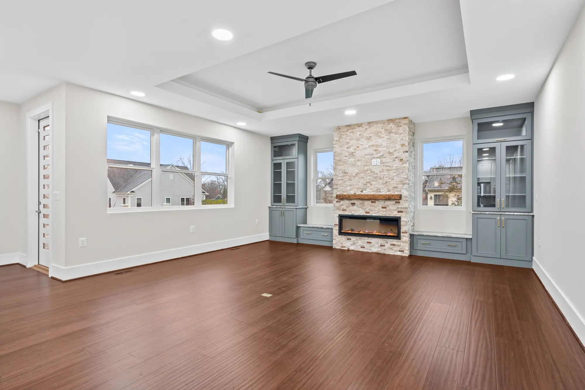 Spacious family room with large windows in Falls Church single-family home