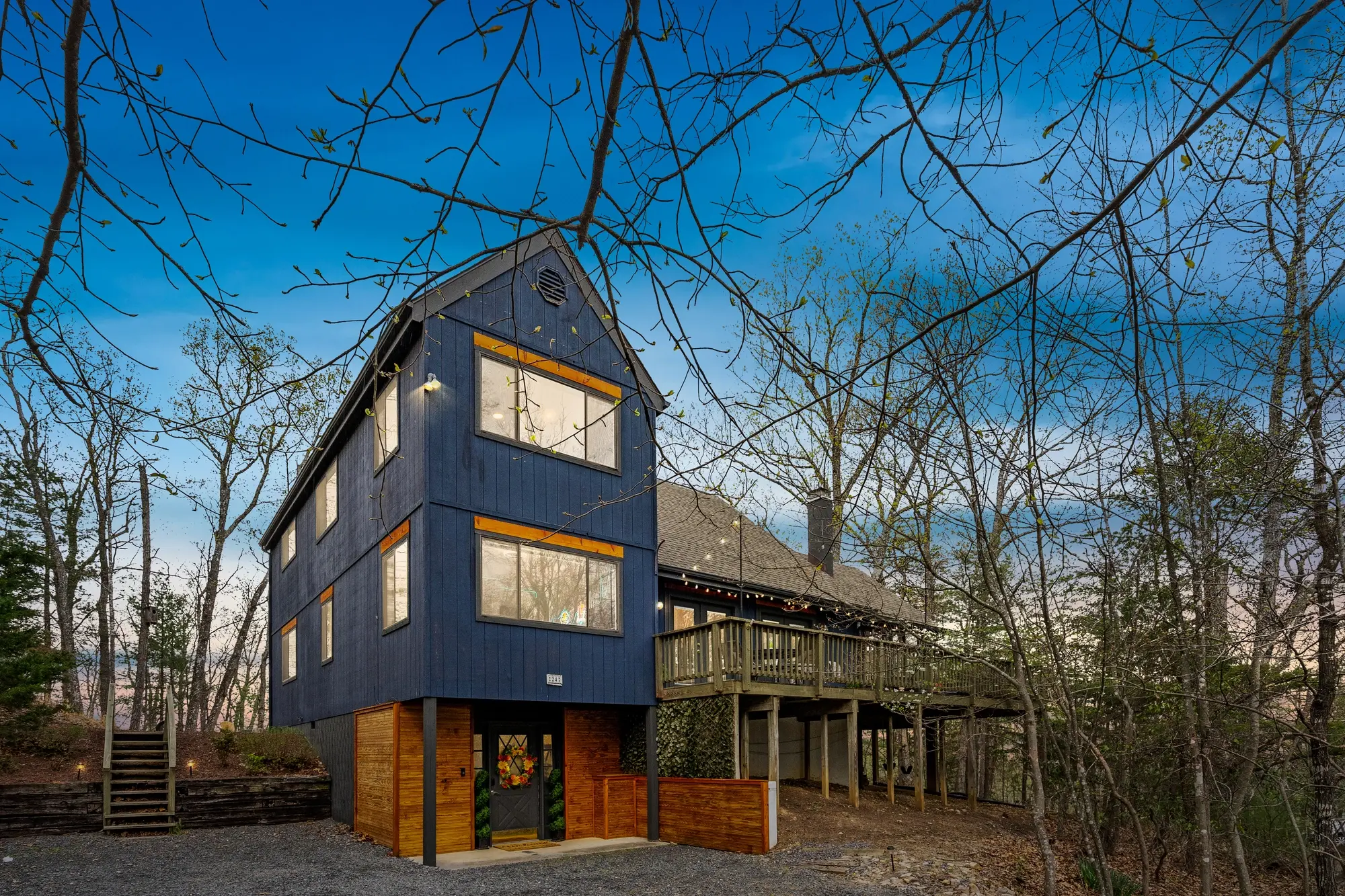 Modern blue mountain cabin exterior in Basye, Virginia - twilight photo