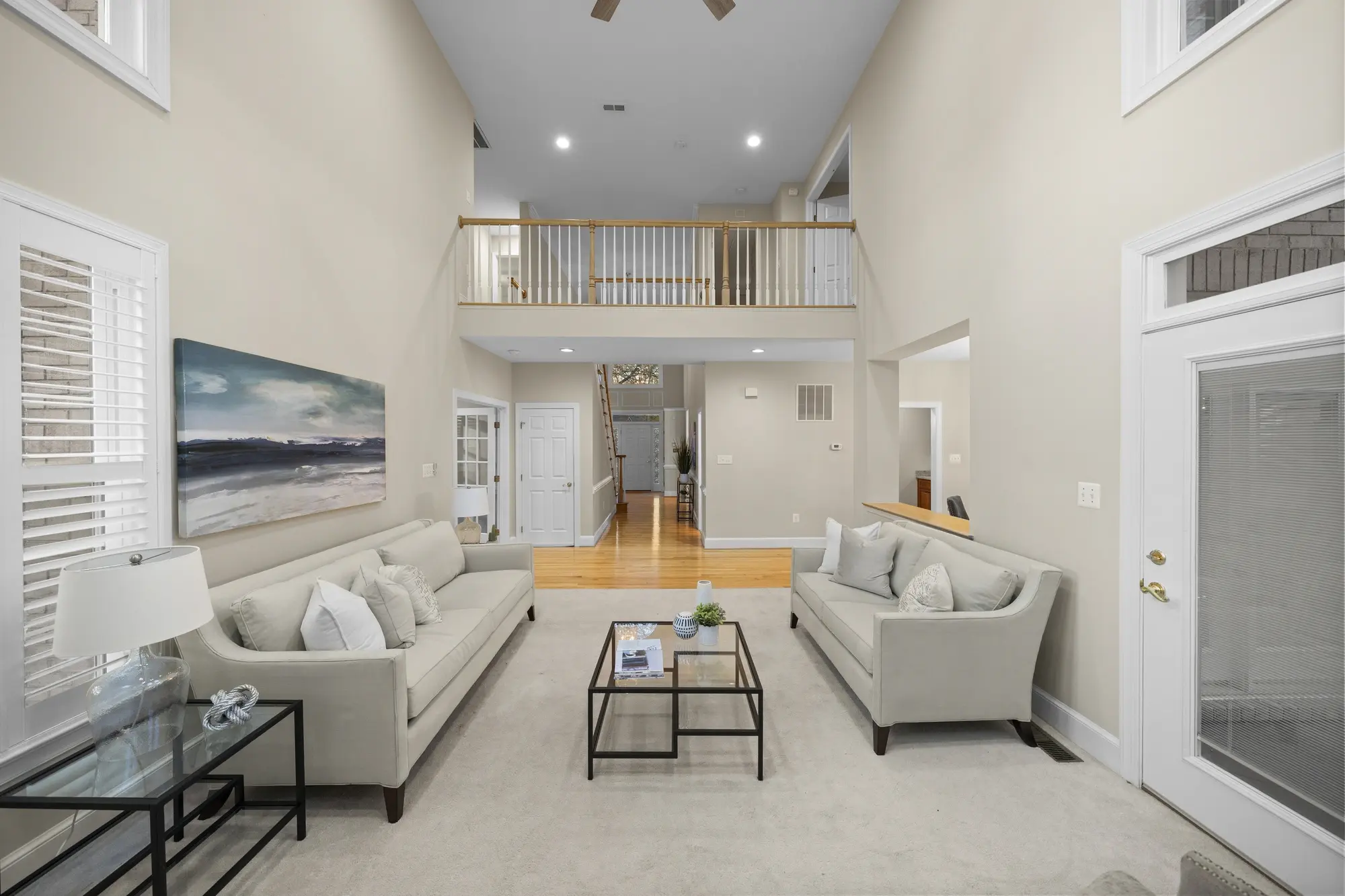 Spacious living room with balcony overlook and modern staging in Oakton VA home — photographed by Umedia real estate media