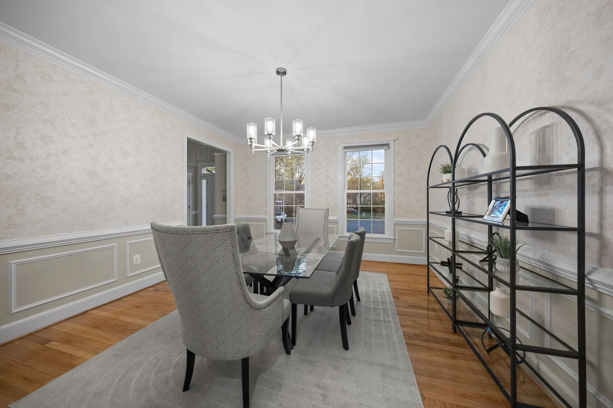 Elegant Oakton VA dining room with glass table, modern chandelier, and stylish staging — photographed by Umedia real estate photography