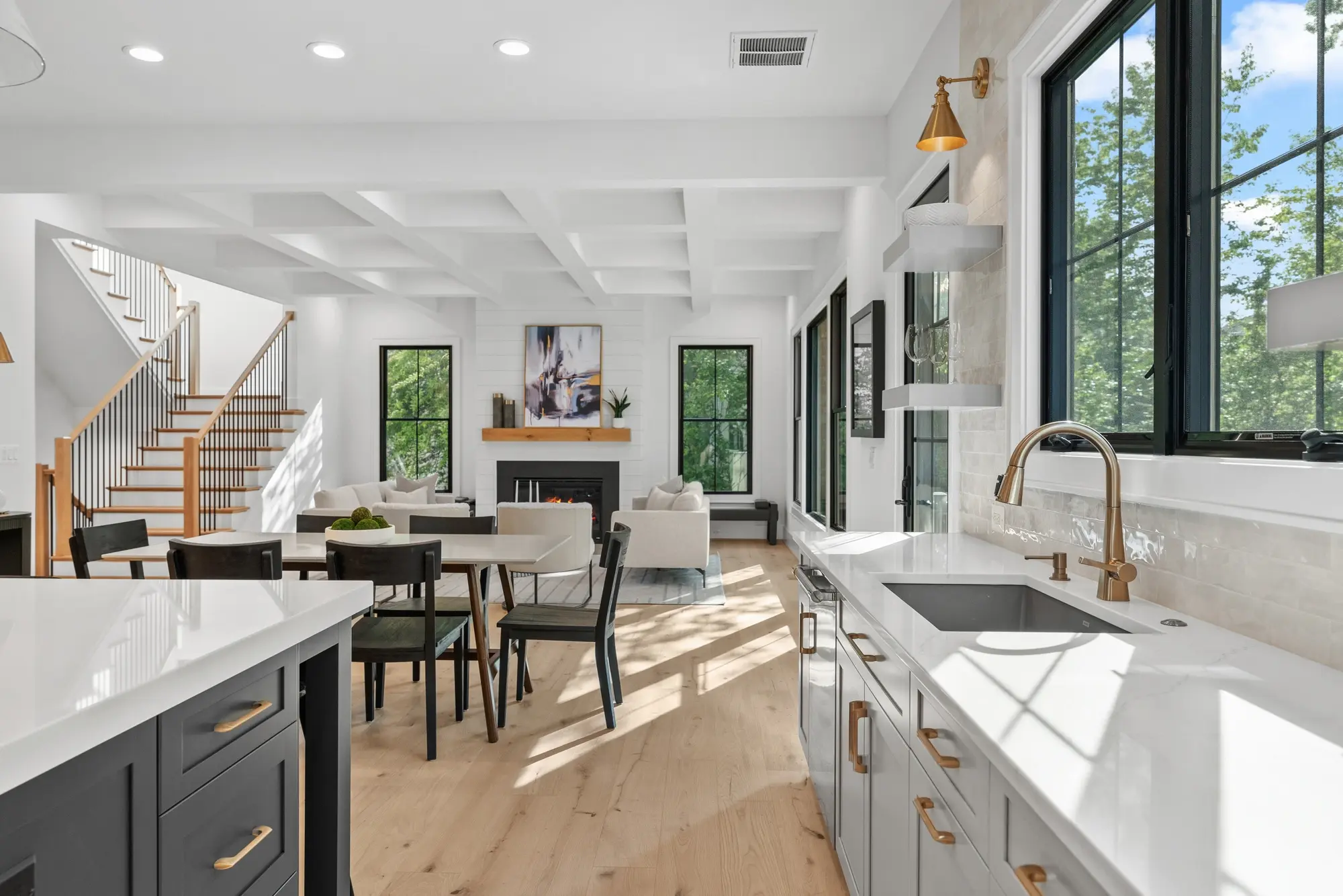 Modern luxury custom home exterior in Arlington VA with white siding, black windows, and metal roof accents