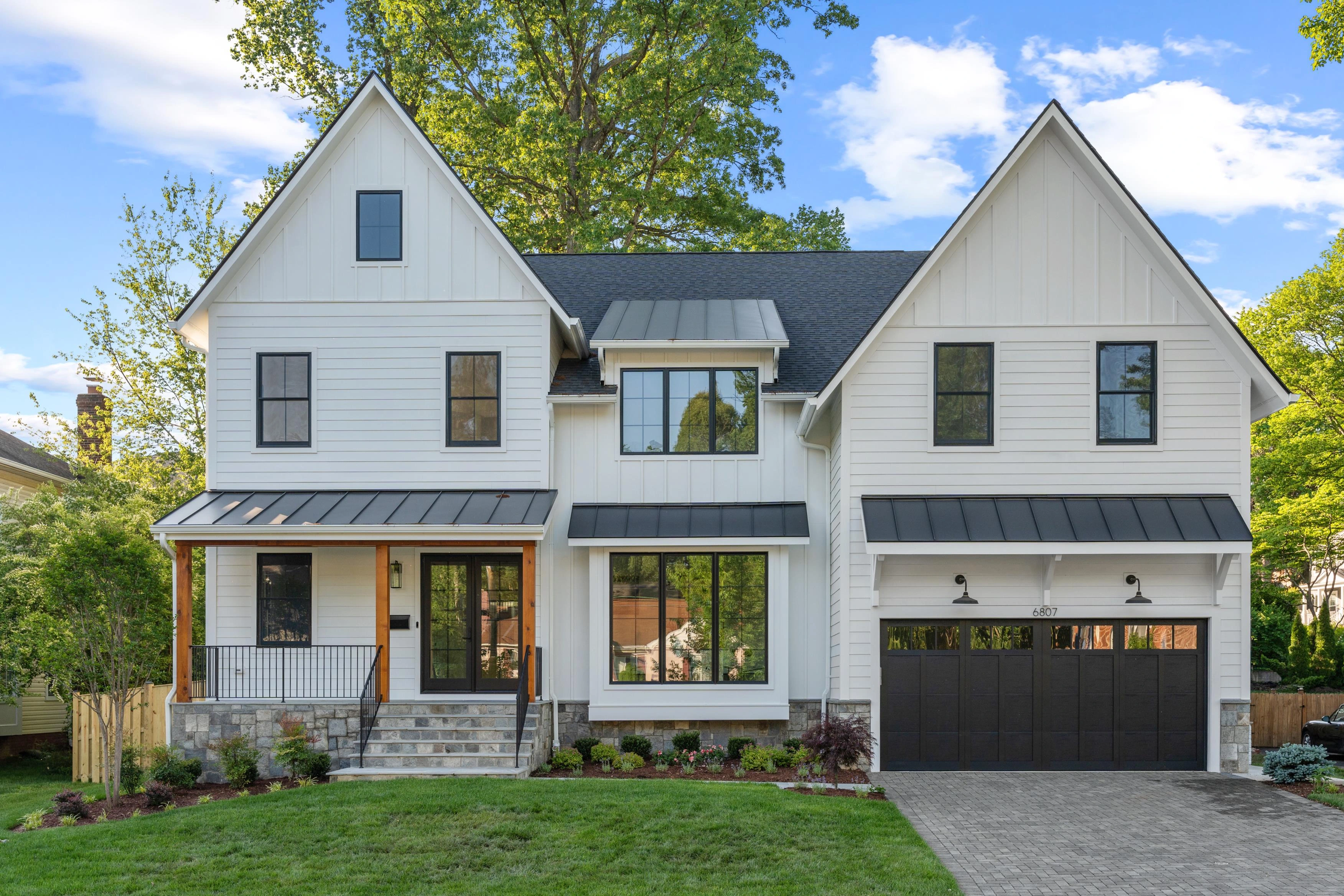 Symmetrical front elevation of custom-built Arlington home with gabled roofline and standing seam metal accents