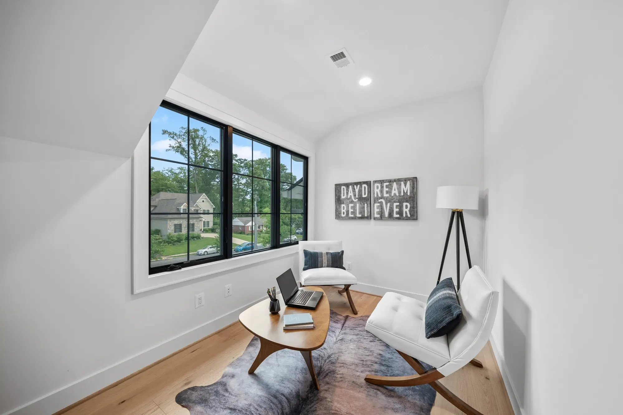 Covered front porch with cedar columns, stone tile floor, and neighborhood view