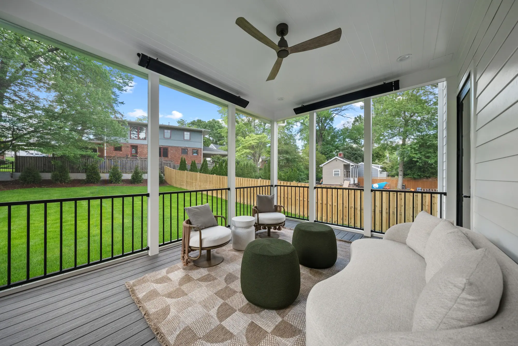 Screened porch with ceiling fan, outdoor sofa, and view of fenced backyard