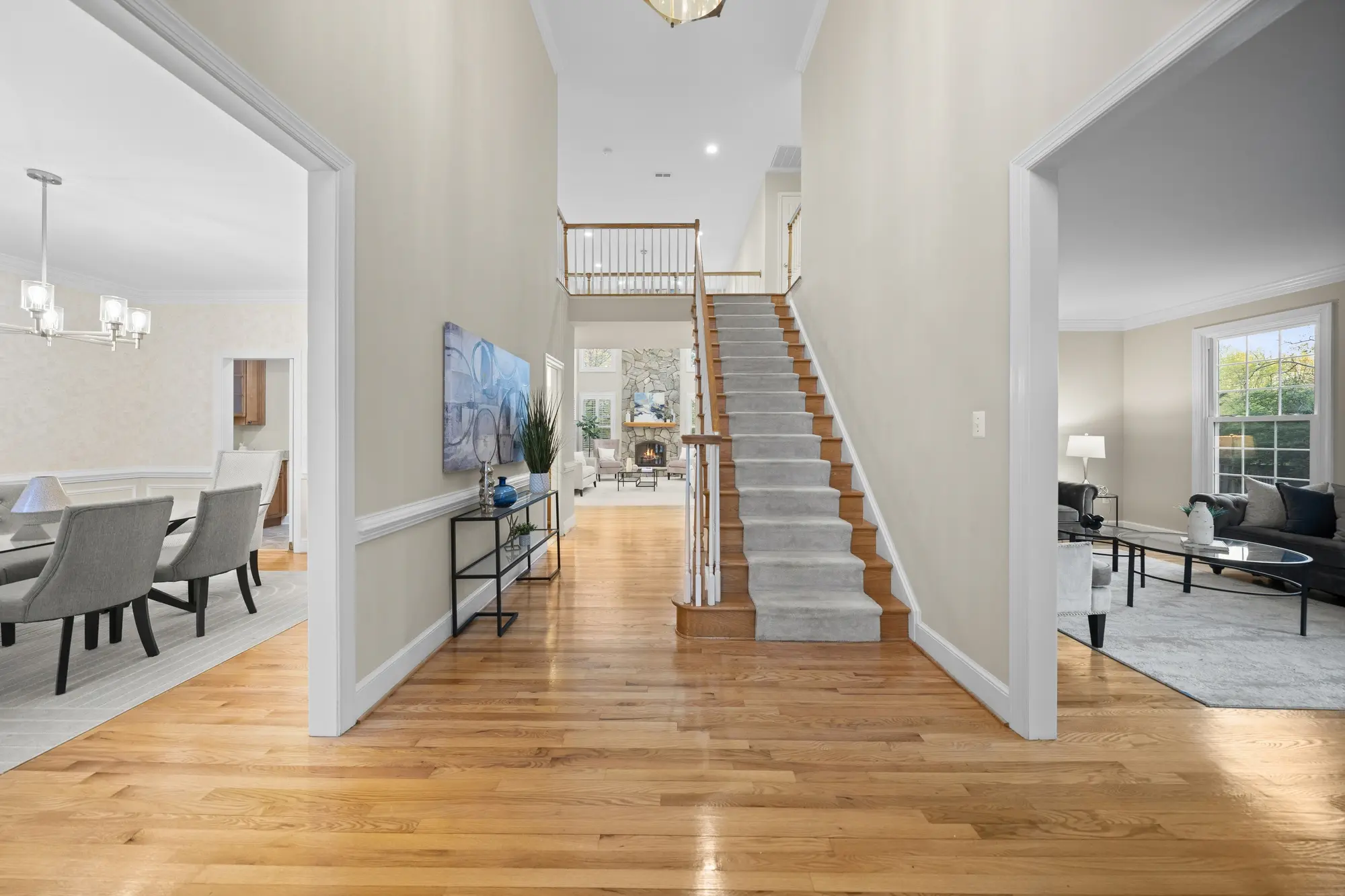 Elegant entryway with hardwood floors and warm lighting in Oakton VA home