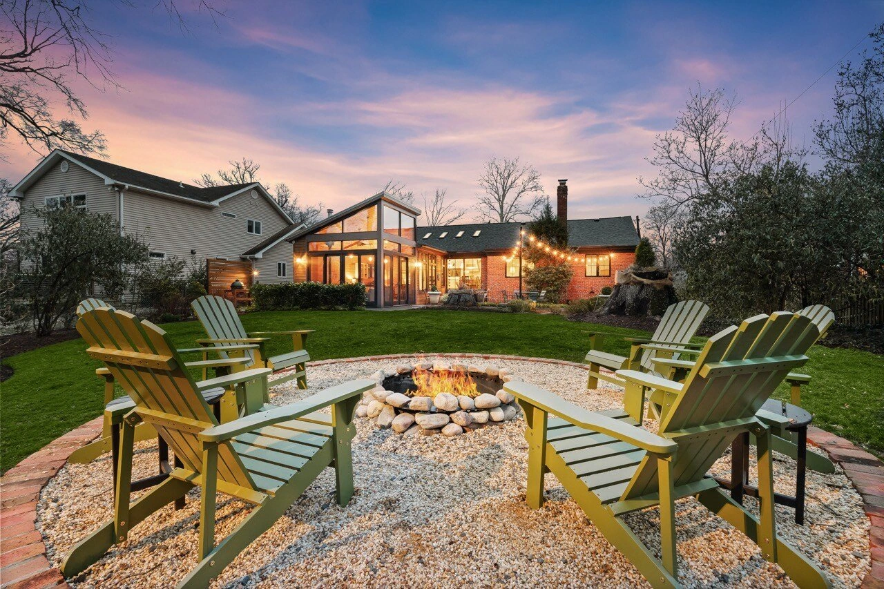 Cozy backyard fire pit with Adirondack chairs at twilight