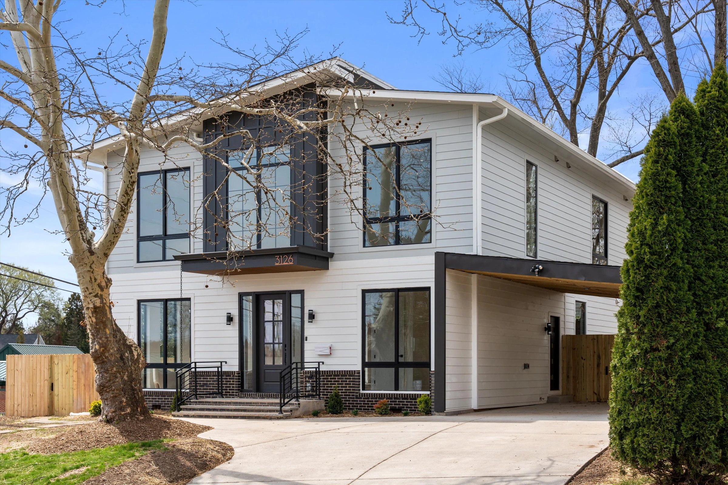 Modern new construction home front exterior at 3126 Westley Rd Falls Church VA with white siding and black-framed windows